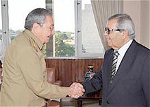 Cuban President Raul Castro greets Libyan Minister of Finance and Planning Abdulahafid M. Zlitni in Havana. President Castro reiterated the call for a negotiated settlement to the civil war inside the North African state. by Pan-African News Wire File Photos