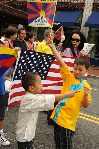 Two boys, Tibetan people parade for World Peace with Tibetan & American Flags, near Verizon Center where Kalachakra is being given by His Holiness the 14th Dalai Lama, Washington D.C., USA by Wonderlane