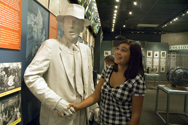 Young visitor shakes the hand of an Oppenheimer statue