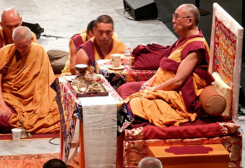 From his short throne with table, orange & maroon robes, His Holiness the 14th Dalai Lama blessing the Kalachakra mandala in preparation for the Initiation, Namgyal monks and lamas, string still connected,  Kalachakra for World Peace, Washington D.C., USA by Wonderlane