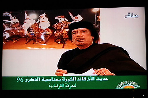Poster Libyan revolutionary leader Muammar Gaddafi speaking on television in the North African oil-rich state. Libya has fought off an imperialist onslaught for nearly a year. by Pan-African News Wire File Photos