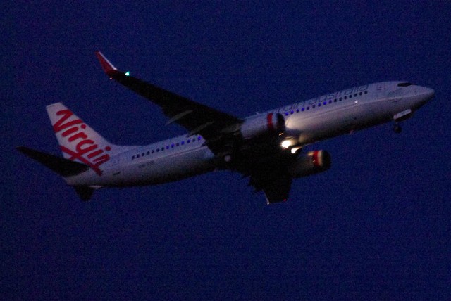 Virgin Australia Plane Flying in At Sunset With Lights