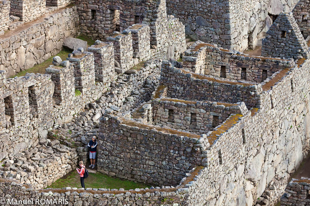 Machu Picchu, Peru, two tourists explore the ruins
