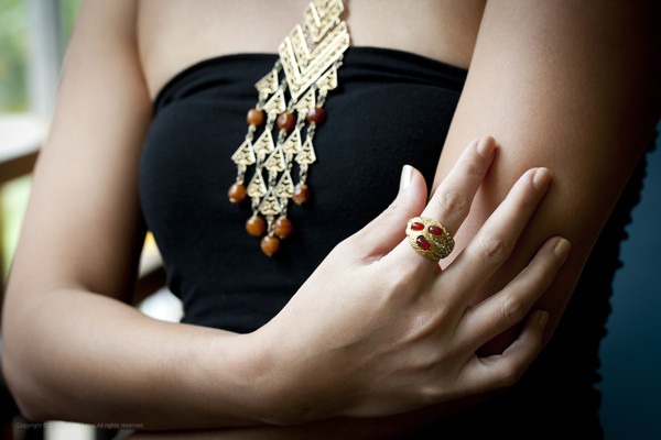 Background: 1960s gold-toned medieval necklace with brown beads; Foreground: Gold-toned ring with brown beads and crystals