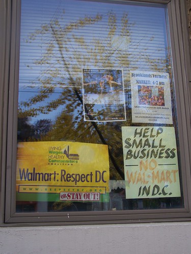 signs in a store window against Walmart's entry into Washington, DC, Brookland neighborhood