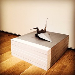 "Origami crane atop paper stack" collaboration F√©lix Gonz√°lez-Torres & Matt Maldre