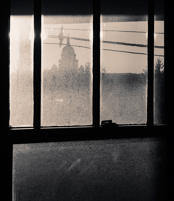dirty window, power lines, state house