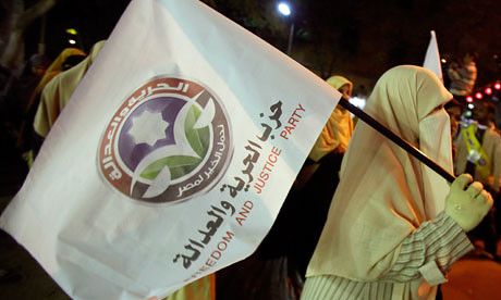 A demonstrator carries the flag of the Muslim Brotherhood in the North African state of Egypt. The Brotherhood may seek the presidency in the upcoming national poll. by Pan-African News Wire File Photos