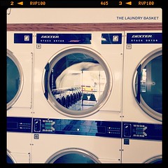 At the laundry basket washing comforter.