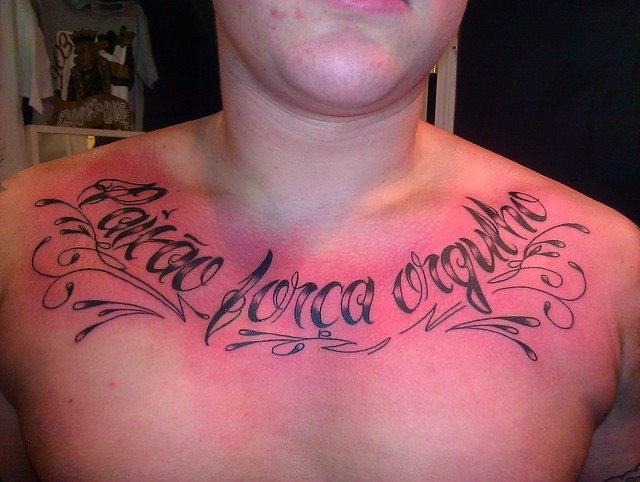 Portugese chest script rocker tattoo by Wes Fortier
