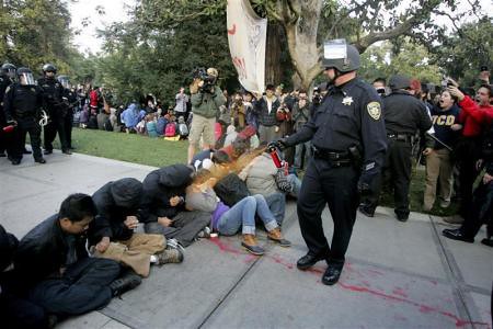 Cops spraying pepper chemicals into the faces of students at the University of California at Davis. The acts of police brutality have been condemned throughout the country.