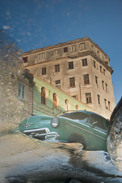 Green car reflected in a puddle Havana Cuba See more images at