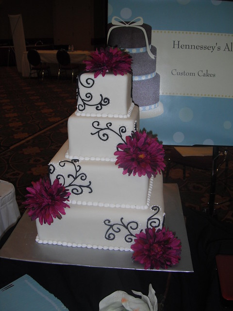 white and black wedding cake with purple daisies