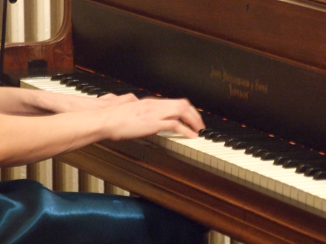 Hands on a grand piano