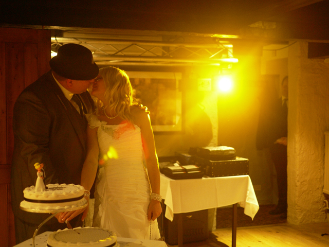 cutting wedding cake disco lights at Wainstones Hotel Great Broughton 