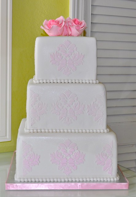 3 Tier White Wedding Cake decorated with pink royal icing damask pattern and