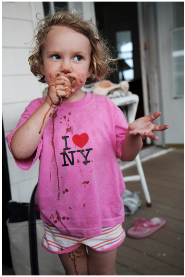 Toddler enjoying her chocolate ice cream and making a gigantic mess