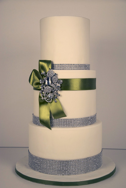 bling wedding cake A tall 3 tier white fondant wedding cake trimmed with 