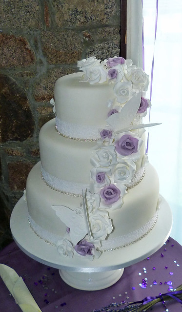 3 tier vintage style wedding cake in a white purple silver theme
