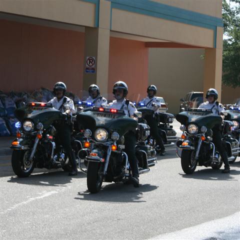 Sheriffs Office Motorcycle Unit escorts the runners into the