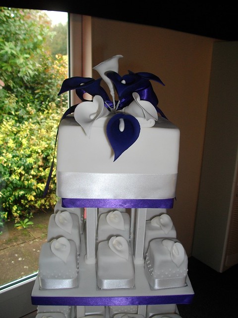 Purple wedding cake The top tier with deep purple and plain white Calla 