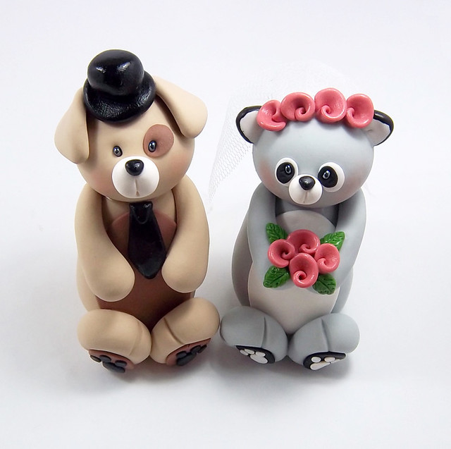 Wedding Cake Topper with a brown puppy as the groom and a racoon as the 