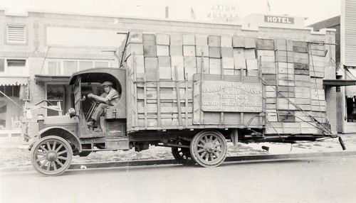 People driving trucks, loaded with produce! 1925