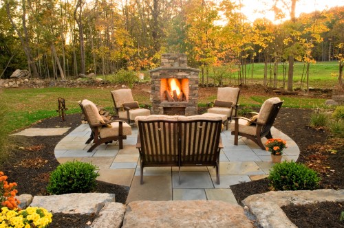outdoor furniture on patio with fireplace
