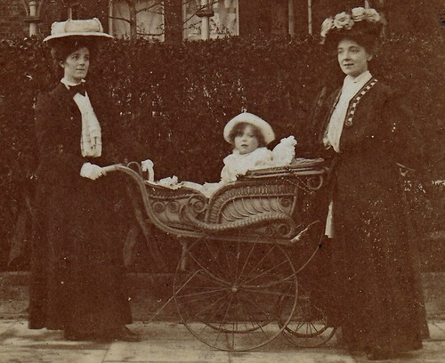 Two ladies and a baby in a wicker pram. (enlarged detail)
