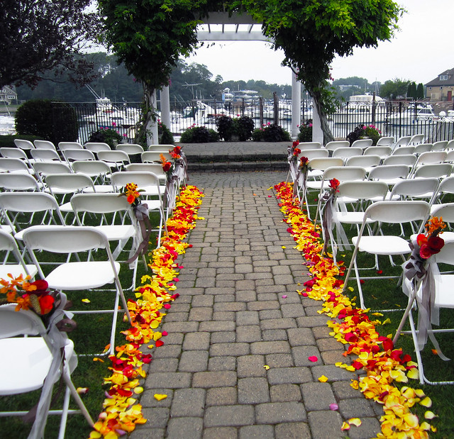Outdoor Wedding Aisle in Yellow and Red Rose Petals