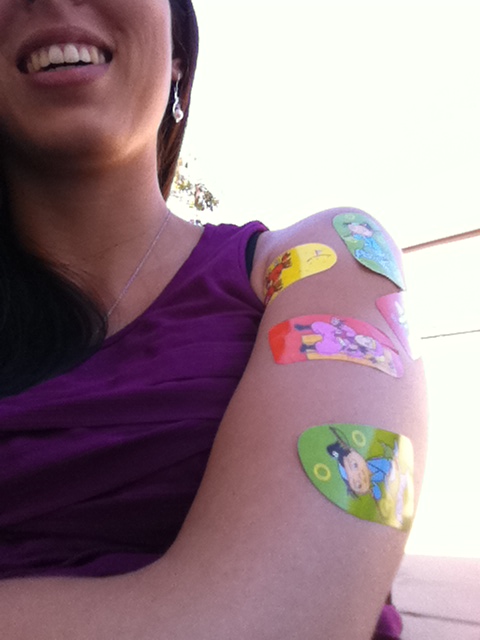 Allison with a bunch of stickers on her arm