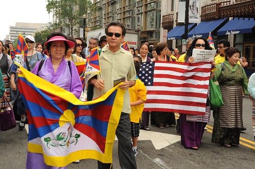 Tibetan and American Flags, Tibetan Association of Southern California, marching in solidarity for peace, women wearing chubas, Happy Birthday to His Holiness the Dalai Lama Parade, Tibetans at Kalachakra, Washington D.C., USA by Wonderlane