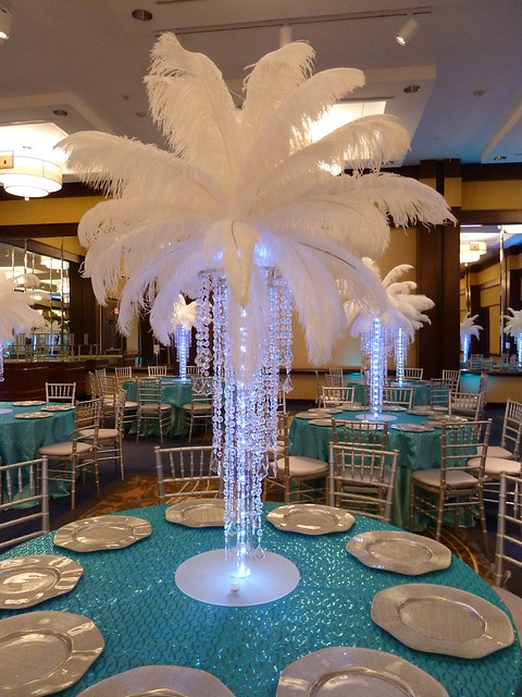 Crystal chandelier light up centerpiece with feathers at the top for a 
