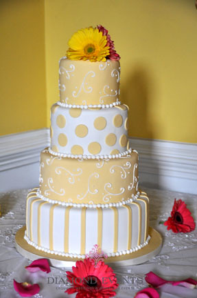 Round 4 tier wedding cake Yellow with stripes dots and piping