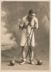 Studio photograph of Houdini in white trunks and chains, c. 1905 by Skirball Cultural Center