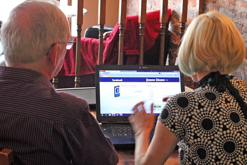 Melissa helping someone learn about Facebook at Dudley Social Media Surgery