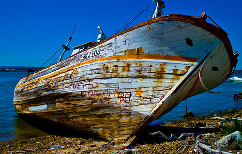Dead fishing boat with graffiti, Spain