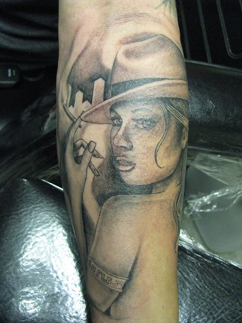 Tattoo of a chicana woman on sleeve