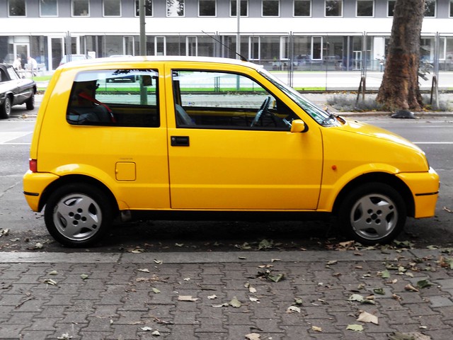 yellow Fiat 500 Sporting