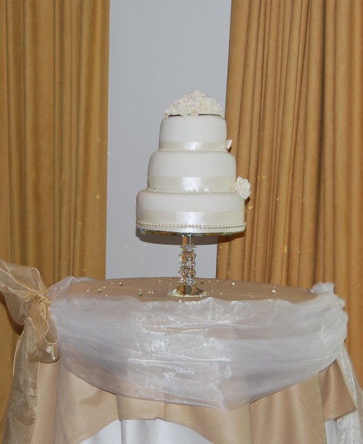 Three tier wedding cake white and champagne rose bouquet
