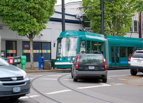 The Portland streetcar turns left off NW 23rd at Lovejoy