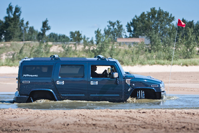 A lifted Hummer H2 going through a surprisingly deep puddle at the Silver