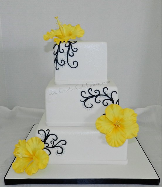 3 tier Wedding cake with black detailing 3 yellow hibiscus gumpaste flowers