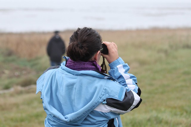 Ann with binoculars looking at birds