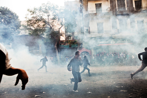 Egyptians scatter after security forces fire teargas at a crowd protesting the repression meted out by the military regime. Egypt has undergone a revolt since the beginning of 2011. by Pan-African News Wire File Photos