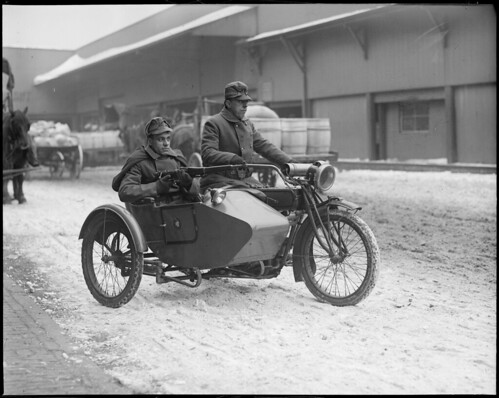 National guardsmen in motorcycle and sidecar guard waterfront from German spies