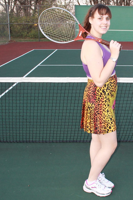 Tennis outfit: Versace for H&M silk pleated skirt, Brooks running shoes, Champion sports bra, vintage Wilson tennis racket