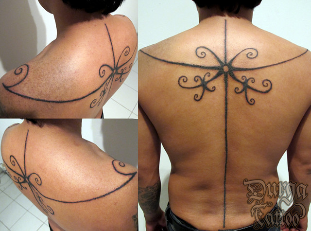 A custom back tattoo based on Mentawai tattoo motive for male's back Serepak