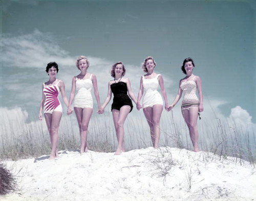 Unidentified young women modeling on a sand dune at the beach: Panama City, Florida