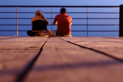 two people woman man color horizontal night outdoors wooden high focus couple sitting dof view floor dusk depthoffield greece together thessaloniki enjoying anopoli gentikoule heptapyrgio